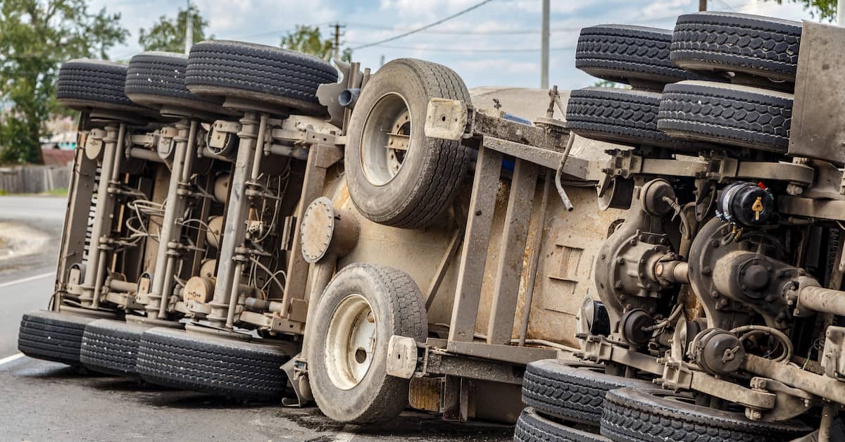 a large semi-truck rolls over | Coplan and Crane