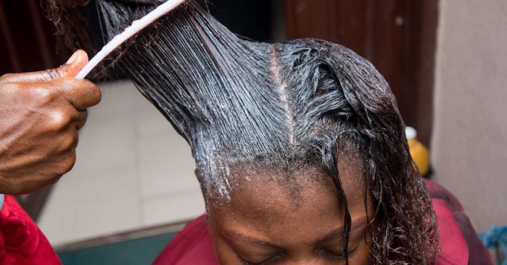 woman receives hair relaxer treatment | Coplan and Crane
