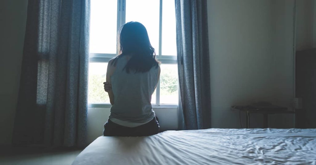 a sexual assault victim looks out a window | Coplan